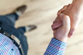 A top down view of a handshake.